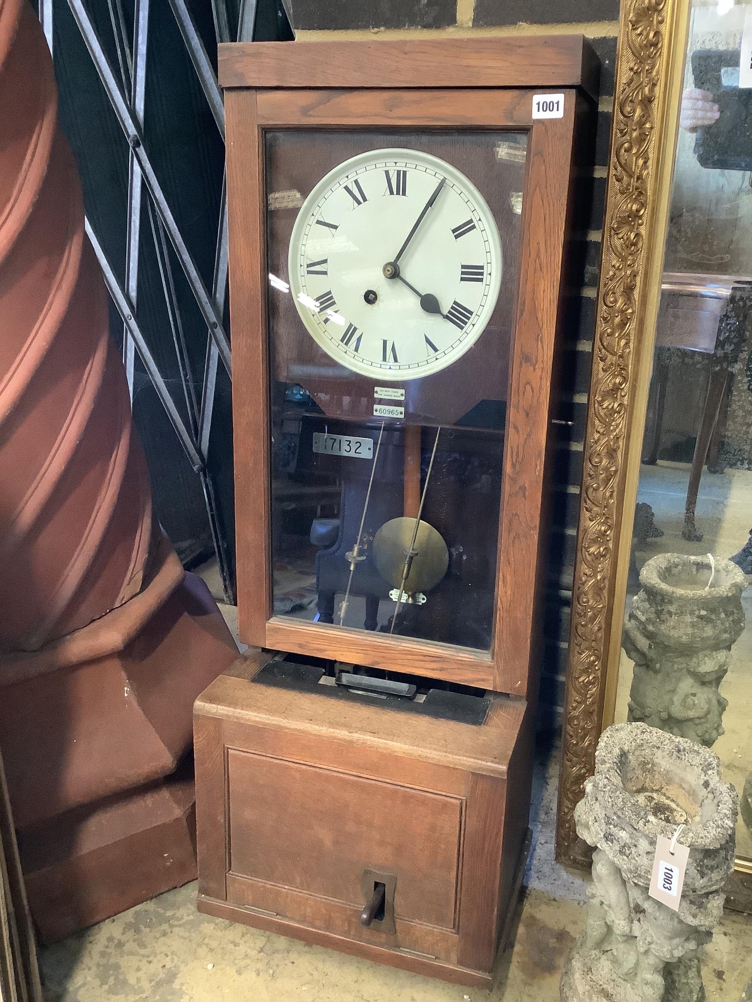 An early 20th century oak cased clocking in clock, height 116cm